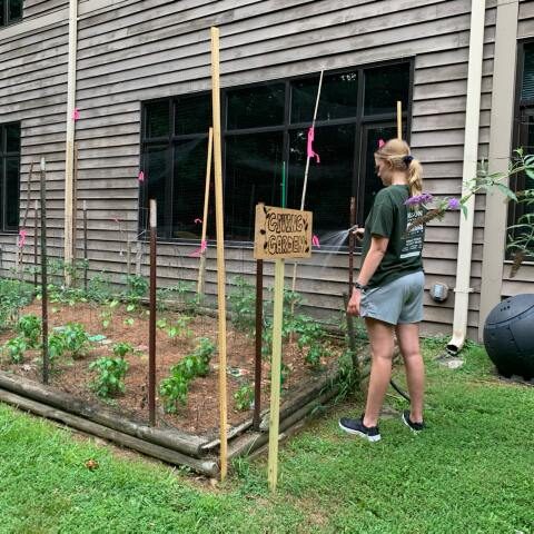 Paige Donovan watering Giving Garden